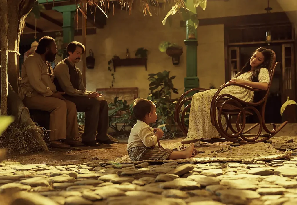 In a backyard, a family scene from One Hundred Years of Solitude shows a child on the ground and a woman in labor.